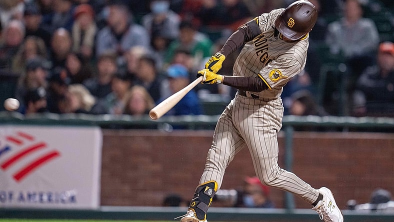 Sep 15, 2021; San Francisco, California, USA; San Diego Padres second baseman Adam Frazier (12) singles to right field against the San Francisco Giants during the fifth inning at Oracle Park. Mandatory Credit: Neville E. Guard-USA TODAY Sports
