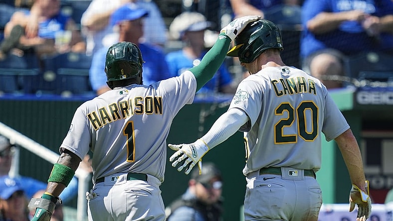 Sep 16, 2021; Kansas City, Missouri, USA; Oakland Athletics third baseman Josh Harrison (1) and left fielder Mark Canha (20) celebrate after scoring against the Kansas City Royals during the third inning at Kauffman Stadium. Mandatory Credit: Jay Biggerstaff-USA TODAY Sports