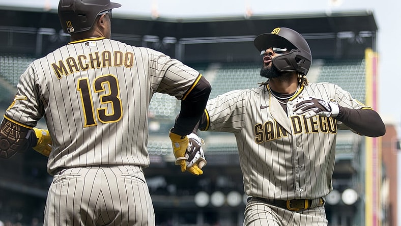 Sep 16, 2021; San Francisco, California, USA; San Diego Padres shortstop Fernando Tatis Jr. (23) celebrates his solo home run against the San Francisco Giants with teammate Manny Machado (13) during the third inning at Oracle Park. Mandatory Credit: D. Ross Cameron-USA TODAY Sports