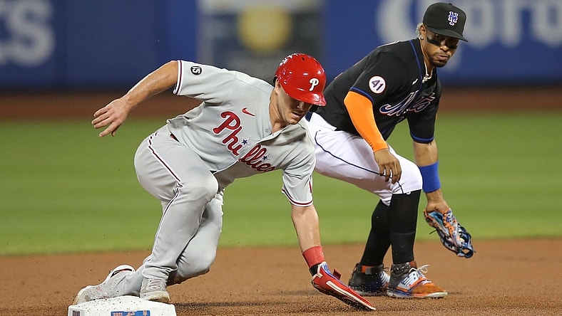 Sep 17, 2021; New York City, New York, USA; Philadelphia Phillies catcher J.T. Realmuto (10) steals second base ahead of a tag by New York Mets shortstop Francisco Lindor (12) during the second inning at Citi Field. Mandatory Credit: Brad Penner-USA TODAY Sports