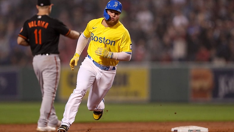 Sep 17, 2021; Boston, Massachusetts, USA; Boston Red Sox left fielder Alex Verdugo (right) advances to third base during the second inning against the Baltimore Orioles at Fenway Park. Mandatory Credit: Paul Rutherford-USA TODAY Sports