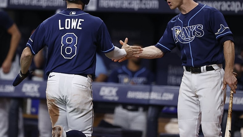 Sep 17, 2021; St. Petersburg, Florida, USA; Tampa Bay Rays second baseman Brandon Lowe (8) is congratulated by Tampa Bay Rays third baseman Joey Wendle (18) as he scores a run during the ninth inning against the Detroit Tigers  at Tropicana Field. Mandatory Credit: Kim Klement-USA TODAY Sports