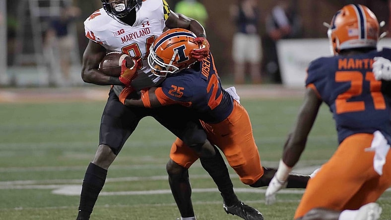 Sep 17, 2021; Champaign, Illinois, USA;  Illinois Fighting Illini defensive back Kerby Joseph (25) tackles Maryland Terrapins tight end Corey Dyches (84) in the first half at Memorial Stadium. Mandatory Credit: Ron Johnson-USA TODAY Sports