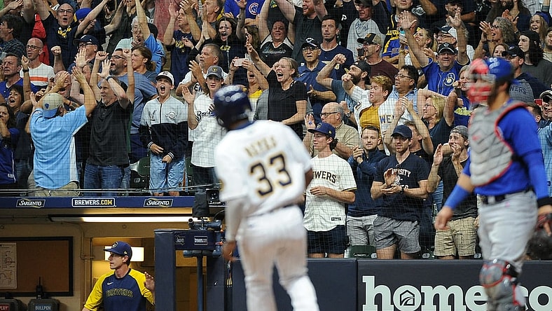 Sep 17, 2021; Milwaukee, Wisconsin, USA; Milwaukee Brewers left fielder Pablo Reyes (33) scores a run as fans cheer in the stands in the eighth inning against the Chicago Cubs at American Family Field. Mandatory Credit: Michael McLoone-USA TODAY Sports