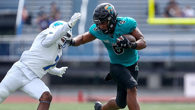 Sep 18, 2021; Buffalo, New York, USA; Coastal Carolina Chanticleers wide receiver Aaron Bedgood (3) stiff arms Buffalo Bulls safety E.J. Brown (7) during the second quarter of play at UB Stadium. Mandatory Credit: Nicholas LoVerde-USA TODAY Sports