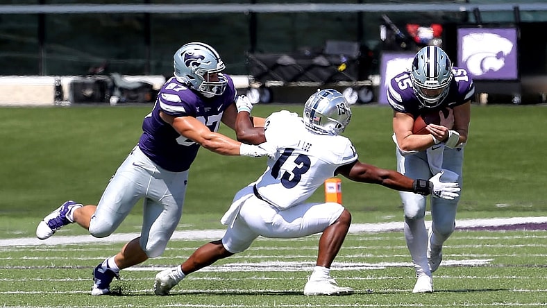 Sep 18, 2021; Manhattan, Kansas, USA; Nevada Wolf Pack defensive back Jordan Lee (13) tries to break away from the block by Kansas State Wildcats tight end Nick Lenners (87) to tackle Wildcats quarterback Will Howard (15) during the first quarter of a game at Bill Snyder Family Football Stadium. Mandatory Credit: Scott Sewell-USA TODAY Sports