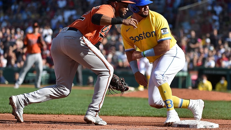 Sep 18, 2021; Boston, Massachusetts, USA; Boston Red Sox left fielder Kyle Schwarber (18) safely slides in third base past Baltimore Orioles third baseman Kelvin Gutierrez (82) during the seventh inning at Fenway Park. Mandatory Credit: Bob DeChiara-USA TODAY Sports