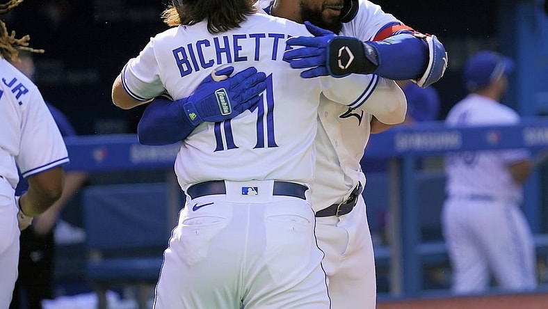 Sep 18, 2021; Toronto, Ontario, CAN; Toronto Blue Jays shortstop Bo Bichette (11) congratulates right fielder Teoscar Hernandez (37) on his three-run home run against the Minnesota Twins during the fourth inning at Rogers Centre. Mandatory Credit: John E. Sokolowski-USA TODAY Sports