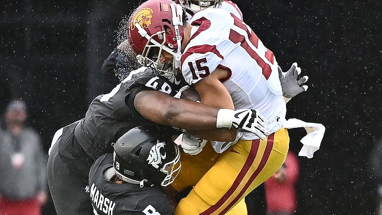 Sep 18, 2021; Pullman, Washington, USA; USC Trojans wide receiver Drake London (15) is hit hard by Washington State Cougars defensive lineman Amir Mujahid (48) and Washington State Cougars defensive back Armani Marsh (8) in the first half at Gesa Field at Martin Stadium. Mandatory Credit: James Snook-USA TODAY Sports