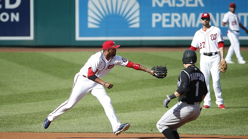 Sep 18, 2021; Washington, District of Columbia, USA; Washington Nationals shortstop Alcides Escobar (3) reaches for the ball as Colorado Rockies center baseman Garrett Hampson (1) runs to second base in the second inning at Nationals Park. Mandatory Credit: Amber Searls-USA TODAY Sports