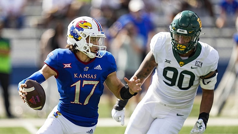 Sep 18, 2021; Lawrence, Kansas, USA; Kansas Jayhawks quarterback Jason Bean (17) scrambles from Baylor Bears defensive lineman TJ Franklin (90) during the first half at David Booth Kansas Memorial Stadium. Mandatory Credit: Jay Biggerstaff-USA TODAY Sports