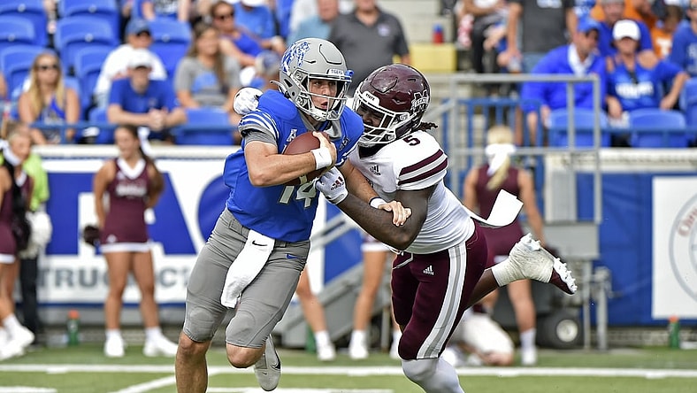 Sep 18, 2021; Memphis, Tennessee, USA; Memphis Tigers quarterback Seth Henigan (14) is pressured by Mississippi State Bulldogs defensive end Randy Charlton (5) during the first half at Liberty Bowl Memorial Stadium. Mandatory Credit: Justin Ford-USA TODAY Sports