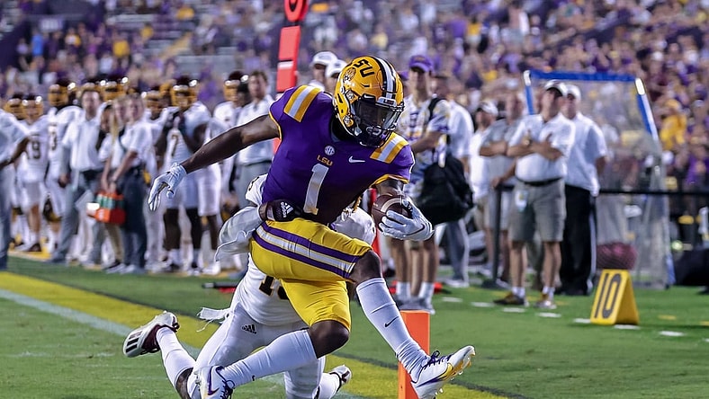 Sep 18, 2021; Baton Rouge, Louisiana, USA;  LSU Tigers wide receiver Kayshon Boutte (1) makes a 2 yard touchdown reception against Central Michigan Chippewas defensive back Donte Kent (19) during the first half at Tiger Stadium. Mandatory Credit: Stephen Lew-USA TODAY Sports