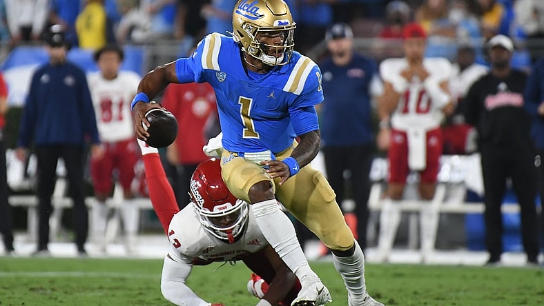 Sep 18, 2021; Pasadena, California, USA; UCLA Bruins quarterback Dorian Thompson-Robinson (1) looks to pass against Fresno State Bulldogs defensive back Justin Houston (13) in the second quarter at Rose Bowl. Mandatory Credit: Richard Mackson-USA TODAY Sports