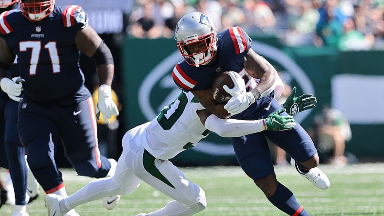 Sep 19, 2021; East Rutherford, New Jersey, USA; New England Patriots running back James White (28) carries the ball as New York Jets cornerback Michael Carter II (30) tackles during the first half at MetLife Stadium. Mandatory Credit: Vincent Carchietta-USA TODAY Sports