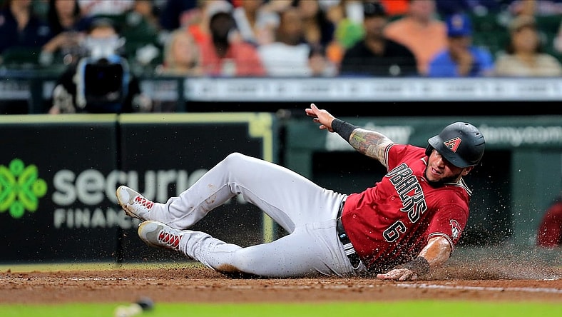 Sep 19, 2021; Houston, Texas, USA; Arizona Diamondbacks left fielder David Peralta (6) slides across home plate to score a run against the Houston Astros during the fourth inning at Minute Maid Park. Mandatory Credit: Erik Williams-USA TODAY Sports