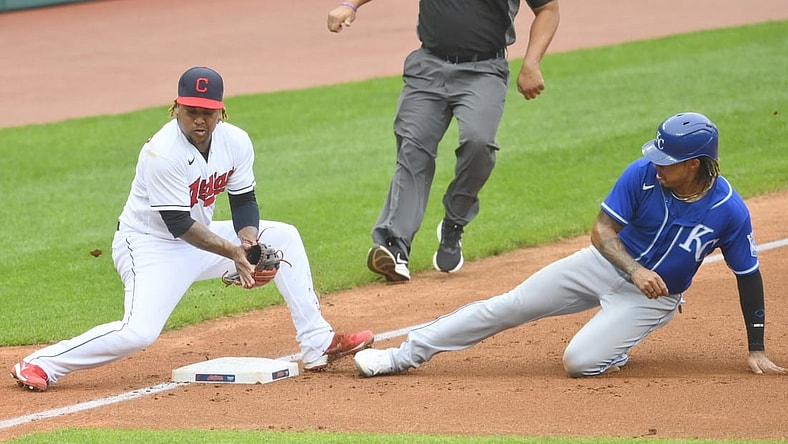 Sep 20, 2021; Cleveland, Ohio, USA; Kansas City Royals third baseman Adalberto Mondesi (27) steals third base beside Cleveland Indians third baseman Jose Ramirez (11) in the second inning at Progressive Field. Mandatory Credit: David Richard-USA TODAY Sports