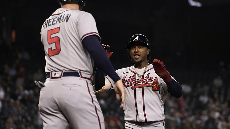 Sep 20, 2021; Phoenix, Arizona, USA; Atlanta Braves second baseman Ozzie Albies (1) celebrates with first baseman Freddie Freeman (5) after scoring runs against the Arizona Diamondbacks in the third inning at Chase Field. Mandatory Credit: Rick Scuteri-USA TODAY Sports