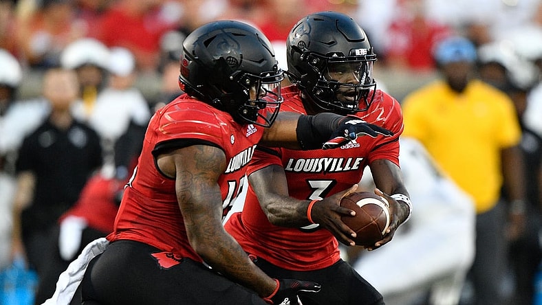 Sep 17, 2021; Louisville, Kentucky, USA;  Louisville Cardinals quarterback Malik Cunningham (3) prepares to handoff the ball to Louisville Cardinals running back Jalen Mitchell (15) during the first quarter against the UCF Knights at Cardinal Stadium. Louisville defeated Central Florida 42-35. Mandatory Credit: Jamie Rhodes-USA TODAY Sports