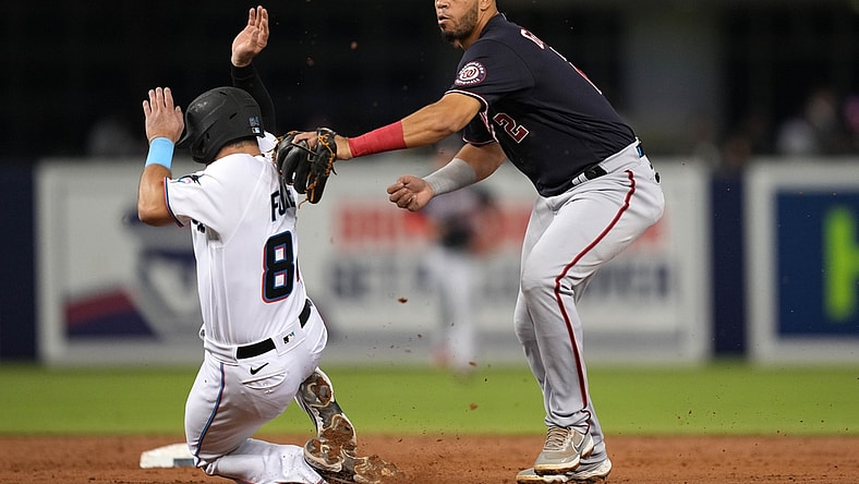 Sep 21, 2021; Miami, Florida, USA; Washington Nationals second baseman Luis Garcia (2) tags out Miami Marlins catcher Nick Fortes (84) while turning a double play in the 2nd inning at loanDepot park. Mandatory Credit: Jasen Vinlove-USA TODAY Sports