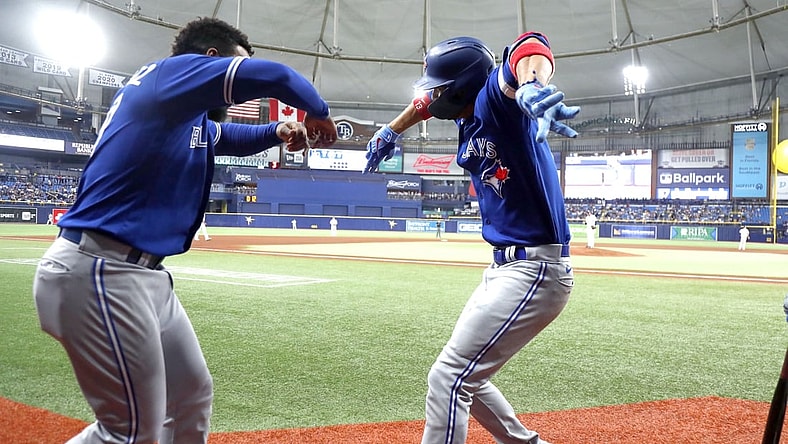Sep 21, 2021; St. Petersburg, Florida, USA; Toronto Blue Jays left fielder Lourdes Gurriel Jr. (right) celebrates with right fielder Teoscar Hernandez (left) after hitting a home run against the Tampa Bay Rays during the fifth inning at Tropicana Field. Mandatory Credit: Kim Klement-USA TODAY Sports