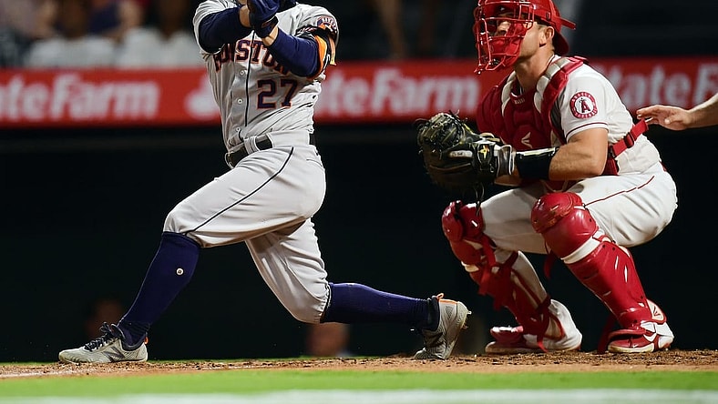 Sep 21, 2021; Anaheim, California, USA; Houston Astros second baseman Jose Altuve (27) hits a two run home run against the Los Angeles Angels during the fifth inning at Angel Stadium. Mandatory Credit: Gary A. Vasquez-USA TODAY Sports