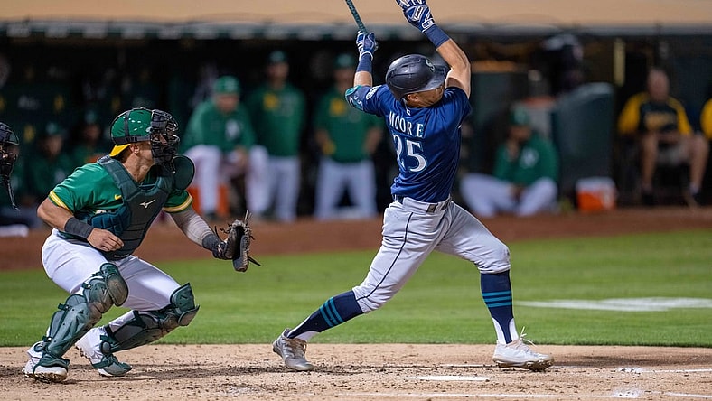 Sep 21, 2021; Oakland, California, USA;  Seattle Mariners second baseman Dylan Moore (25) hits a two run RBI triple during the fourth inning against the Oakland Athletics at RingCentral Coliseum. Mandatory Credit: Neville E. Guard-USA TODAY Sports