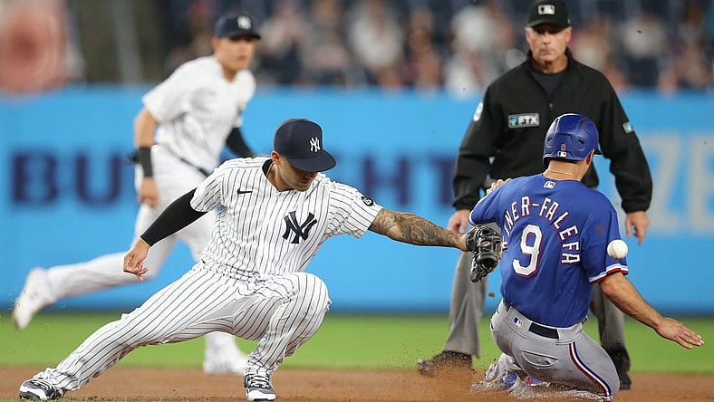Sep 22, 2021; Bronx, New York, USA; Texas Rangers shortstop Isiah Kiner-Falefa (9) steals second base safely as the throw goes past New York Yankees second baseman Gleyber Torres (25) during the first inning at Yankee Stadium. Mandatory Credit: Brad Penner-USA TODAY Sports