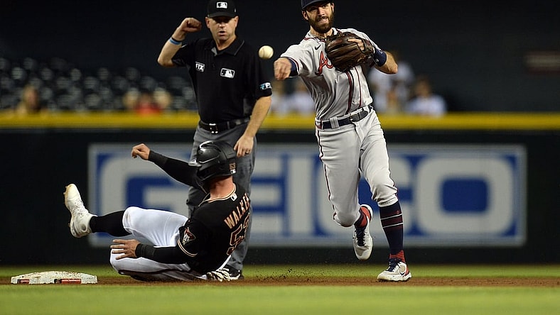 Sep 22, 2021; Phoenix, Arizona, USA; Atlanta Braves shortstop Dansby Swanson (7) throws to first base after forcing Arizona Diamondbacks first baseman Christian Walker (53) at second base during the second inning at Chase Field. Mandatory Credit: Joe Camporeale-USA TODAY Sports