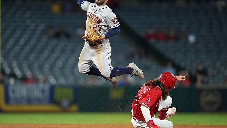 Sep 22, 2021; Anaheim, California, USA; Houston Astros second baseman Jose Altuve (27) forces out Los Angeles Angels center fielder Brandon Marsh (16) at second base in the second inning at Angel Stadium. Mandatory Credit: Kirby Lee-USA TODAY Sports