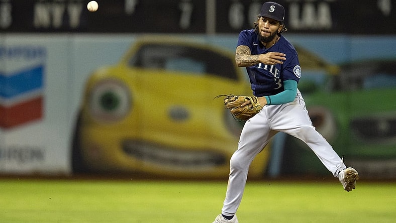 Sep 22, 2021; Oakland, California, USA; Seattle Mariners shortstop J.P. Crawford (3) throws out Oakland Athletics center fielder Starling Marte at first base during the fourth inning at RingCentral Coliseum. Mandatory Credit: D. Ross Cameron-USA TODAY Sports