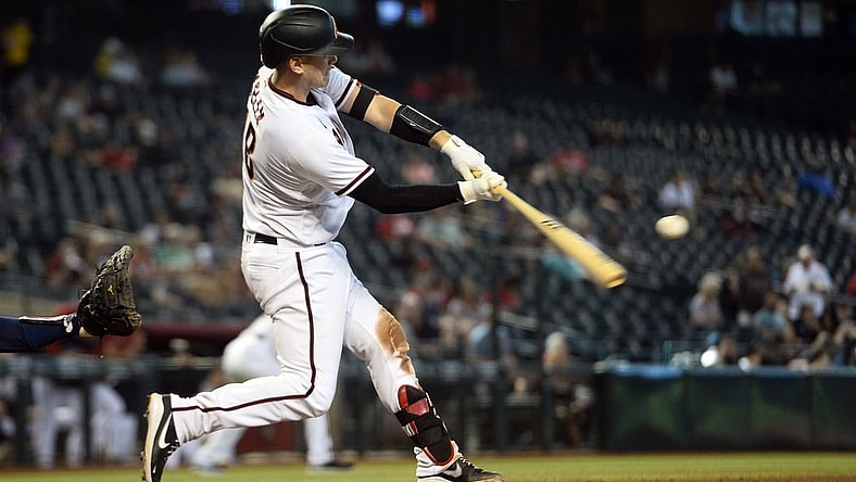 Sep 23, 2021; Phoenix, Arizona, USA; Arizona Diamondbacks catcher Carson Kelly (18) hits a three run home run against the Atlanta Braves during the seventh inning at Chase Field. Mandatory Credit: Joe Camporeale-USA TODAY Sports