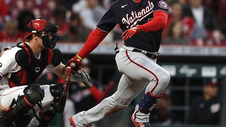 Sep 23, 2021; Cincinnati, Ohio, USA; Washington Nationals right fielder Juan Soto (22) hits a single against the Cincinnati Reds during the third inning at Great American Ball Park. Mandatory Credit: David Kohl-USA TODAY Sports