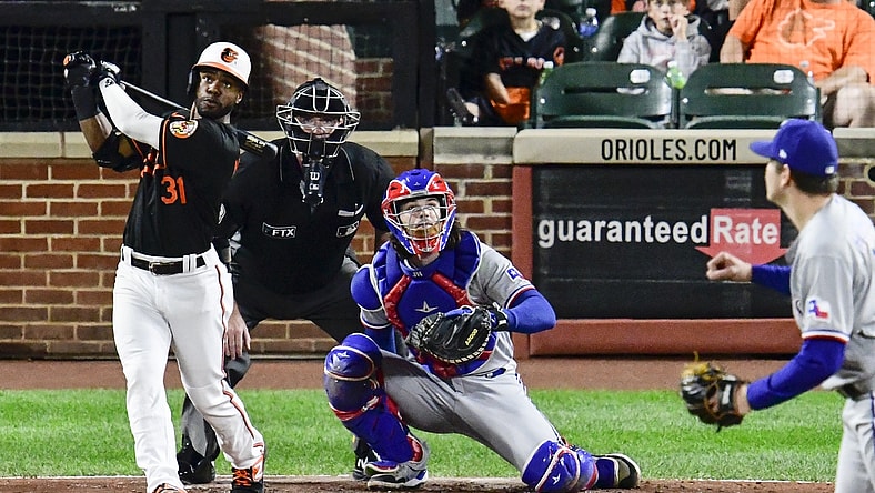 Sep 24, 2021; Baltimore, Maryland, USA;  Baltimore Orioles center fielder Cedric Mullins (31) swings through a three run home run off Texas Rangers starting pitcher Spencer Howard (31) during second inning at Oriole Park at Camden Yards. Mandatory Credit: Tommy Gilligan-USA TODAY Sports