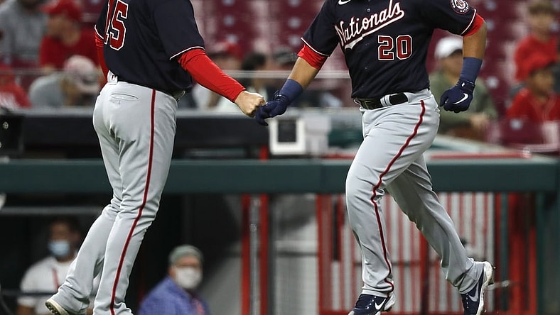 Sep 24, 2021; Cincinnati, Ohio, USA; Washington Nationals catcher Keibert Ruiz (20) celebrates with third base coach Bob Henley (15) after hitting a solo home run against the Cincinnati Reds during the second inning at Great American Ball Park. Mandatory Credit: David Kohl-USA TODAY Sports