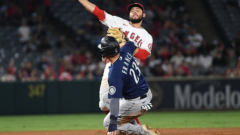 Sep 24, 2021; Anaheim, California, USA; Los Angeles Angels second baseman David Fletcher (22) throws out Seattle Mariners third baseman Ty France (23) as Seattle Mariners shortstop J.P. Crawford (not pictured) scored on the play in the third inning at Angel Stadium. Mandatory Credit: Richard Mackson-USA TODAY Sports