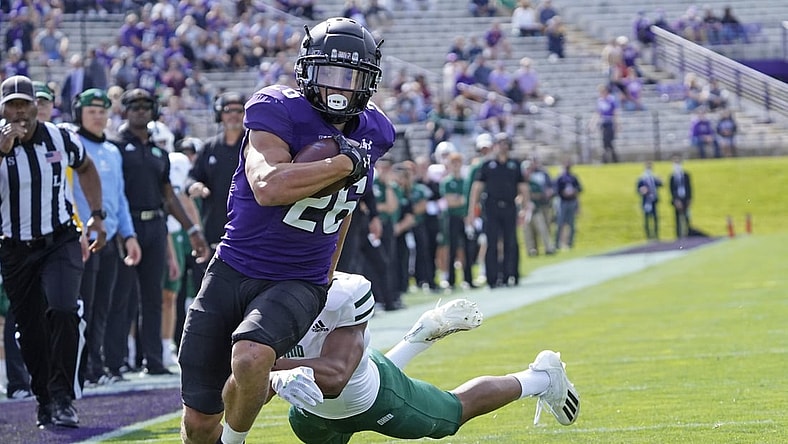 Sep 25, 2021; Evanston, Illinois, USA; Northwestern Wildcats running back Evan Hull (26) runs the ball for a touchdown as Ohio Bobcats cornerback John Gregory (13) pursues him during the first half  at Ryan Field. Mandatory Credit: David Banks-USA TODAY Sports