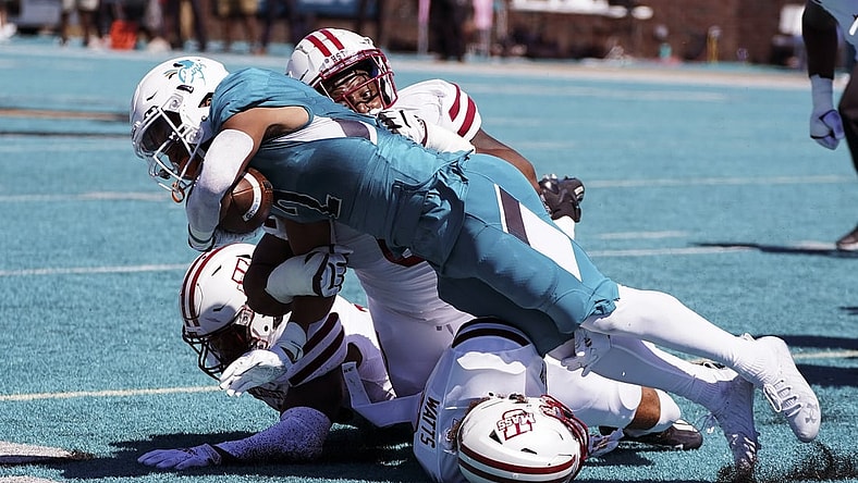 Sep 25, 2021; Conway, South Carolina, USA; Coastal Carolina Chanticleers running back Reese White (2) is tackled by the Massachusetts Minutemen in the NCAA football game of Massachusetts and Coastal Carolina at Brooks Stadium. Mandatory Credit: David Yeazell-USA TODAY Sports