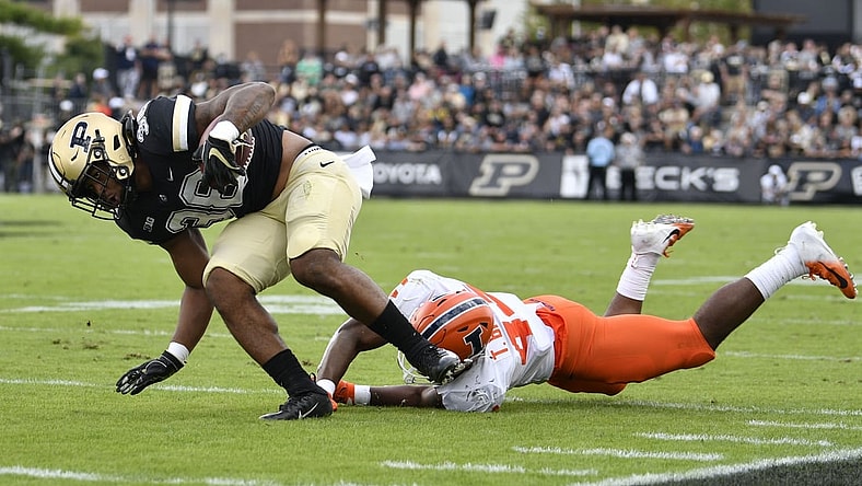 Sep 25, 2021; West Lafayette, Indiana, USA;  Purdue Boilermakers running back Dylan Downing (38) evades a tackle against Illinois Fighting Illini linebacker Tarique Barnes (44) during the first quarter at Ross-Ade Stadium. Mandatory Credit: Marc Lebryk-USA TODAY Sports