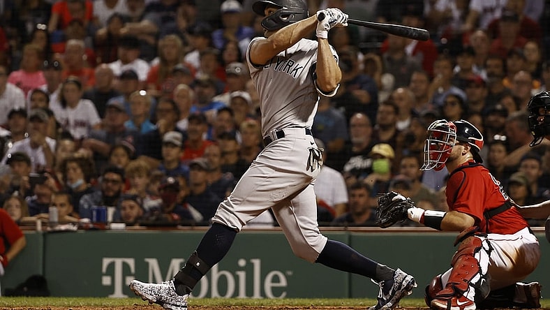 Sep 25, 2021; Boston, Massachusetts, USA; New York Yankees designated hitter Giancarlo Stanton (27) hits a grand slam home run against the Boston Red Sox during the eighth inning at Fenway Park. Mandatory Credit: Winslow Townson-USA TODAY Sports