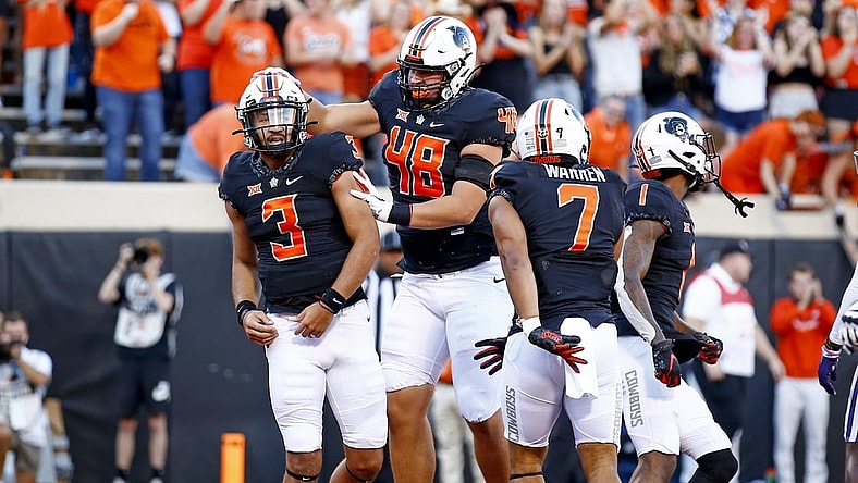 Sep 25, 2021; Stillwater, Oklahoma, USA; Oklahoma State's Spencer Sanders (3) celebrates with teammates after scoring a touchdown against the Kansas State Wildcats in the first quarter at Boone Pickens Stadium. Mandatory Credit: Sarah Phipps-USA TODAY Sports