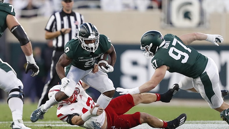 Sep 25, 2021; East Lansing, Michigan, USA; Nebraska Cornhuskers linebacker Nick Henrich (42) attempts to bring down Michigan State Spartans running back Kenneth Walker III (9) during the first quarter at Spartan Stadium. Mandatory Credit: Raj Mehta-USA TODAY Sports