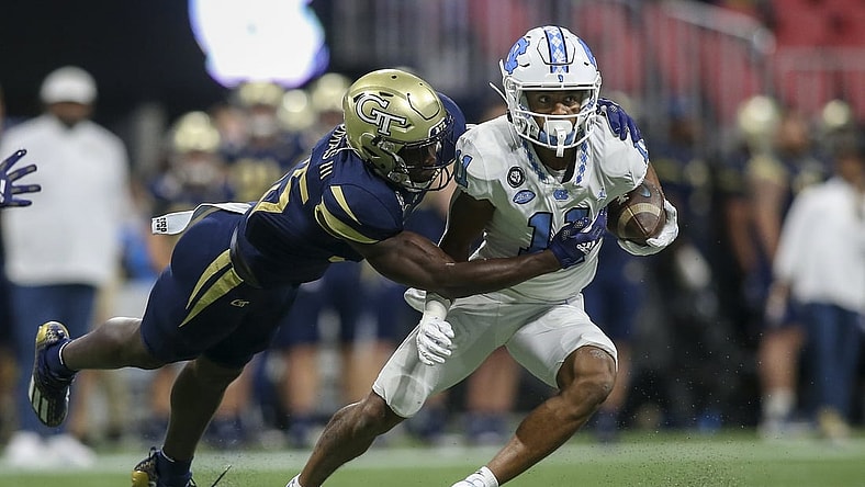 Sep 25, 2021; Atlanta, Georgia, USA; North Carolina Tar Heels wide receiver Josh Downs (11) is tackled by Georgia Tech Yellow Jackets linebacker Charlie Thomas (25) in the first quarter at Mercedes-Benz Stadium. Mandatory Credit: Brett Davis-USA TODAY Sports