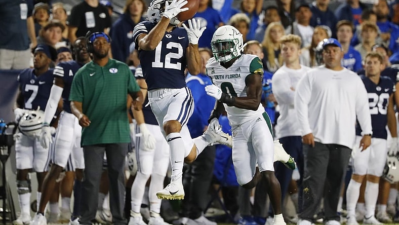Sep 25, 2021; Provo, Utah, USA; Brigham Young Cougars wide receiver Puka Nacua (12) makes a reception for a first down past DUPLICATE***South Florida Bulls defensive back Daquan Evans (0)***South Florida Bulls running back Jaren Mangham (0) in the first quarter at LaVell Edwards Stadium. Mandatory Credit: Jeffrey Swinger-USA TODAY Sports