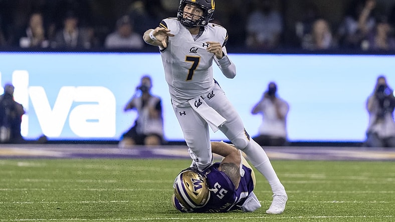 Sep 25, 2021; Seattle, Washington, USA;  California Golden Bears quarterback Chase Garbers (7) throws a passes before getting sacked by Washington Huskies linebacker Ryan Bowman (55) during the first half of a game at Alaska Airlines Field at Husky Stadium. Mandatory Credit: Stephen Brashear-USA TODAY Sports