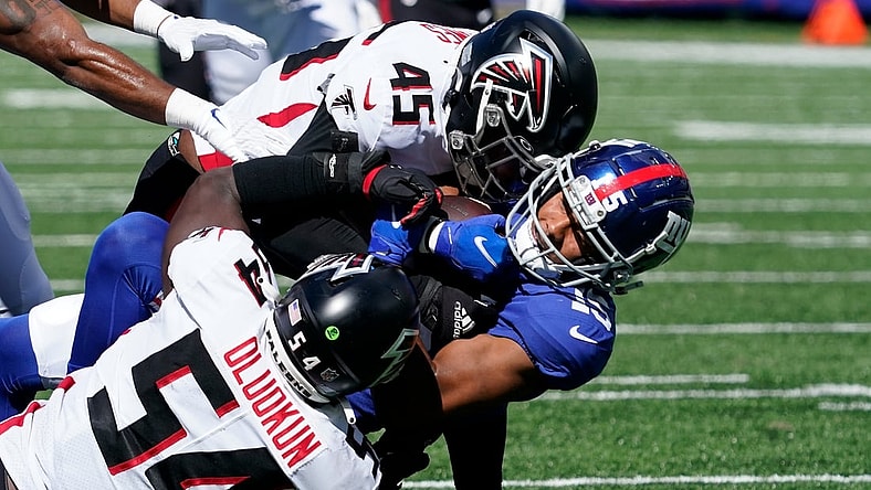 Sep 26, 2021; E. Rutherford, N.J., USA;  New York Giants wide receiver Collin Johnson (15) carries the ball as Atlanta Falcons linebacker Deion Jones (45) and Atlanta Falcons linebacker Foye Oluokun (54) tackle in the first half at MetLife Stadium. Mandatory Credit: Robert Deutsch-USA TODAY Sports