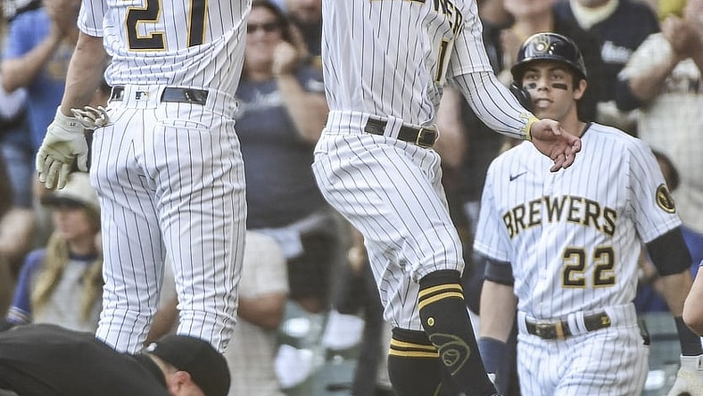 Sep 26, 2021; Milwaukee, Wisconsin, USA;  Milwaukee Brewers shortstop Willy Adames (27) celebrates with second baseman Kolten Wong (16) after hitting a two-run homer in the first inning against the New York Mets at American Family Field. Mandatory Credit: Benny Sieu-USA TODAY Sports