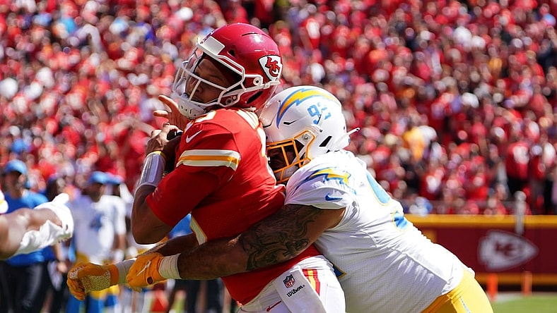 Sep 26, 2021; Kansas City, Missouri, USA; Kansas City Chiefs quarterback Patrick Mahomes (15) is tackled by Los Angeles Chargers defensive tackle Justin Jones (93) during the second half at GEHA Field at Arrowhead Stadium. Mandatory Credit: Denny Medley-USA TODAY Sports