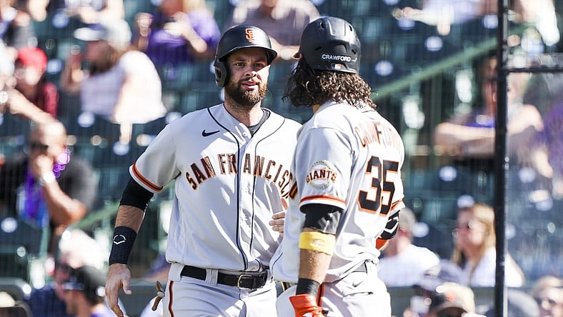 Sep 26, 2021; Denver, Colorado, USA; San Francisco Giants first baseman Brandon Belt (9) celebrates with shortstop Brandon Crawford (35) after scoring against the Colorado Rockies off a hit by left fielder Kris Bryant (23) in the fifth inning at Coors Field. Mandatory Credit: Michael Ciaglo-USA TODAY Sports