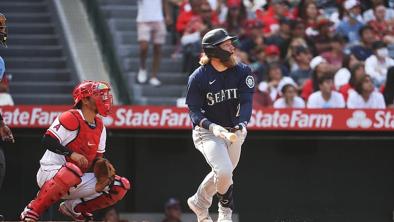 Sep 26, 2021; Anaheim, California, USA; Seattle Mariners left fielder Jake Fraley (28) hits a double against the Los Angeles Angels in the eighth inning at Angel Stadium. Mandatory Credit: Kiyoshi Mio-USA TODAY Sports